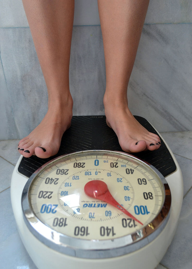 Picture of woman's legs standing on scale